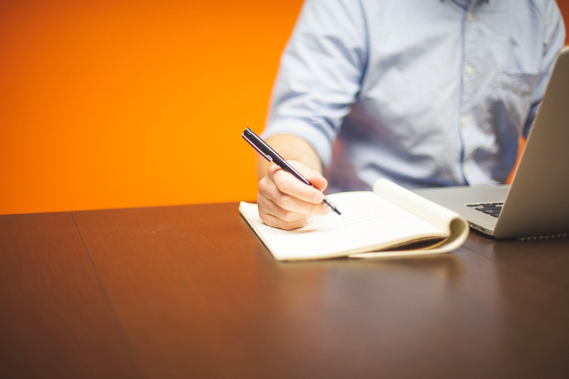 notebook with handwritten investment plan and pen on desk