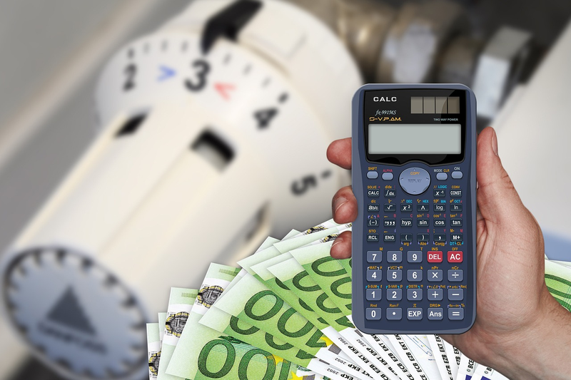 budget planning with monthly expenses listed on paper with calculator