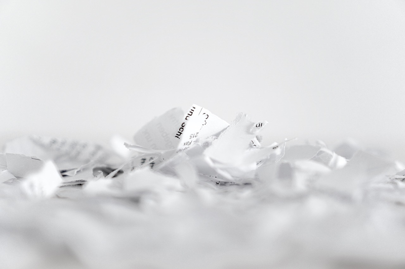 insurance policy papers with scissors cutting them