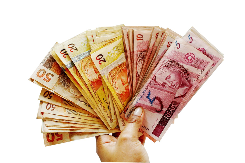 hand holding money bills with calendar showing years