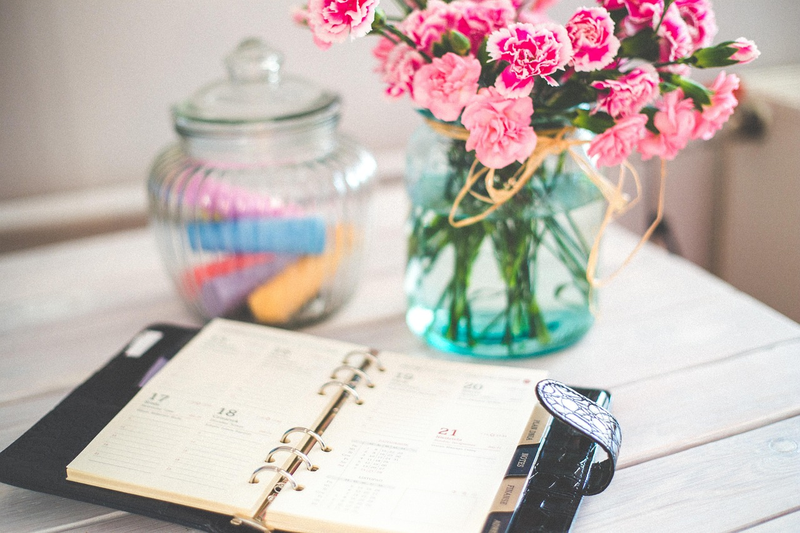 simple organized daily planner on clean desk with minimal items