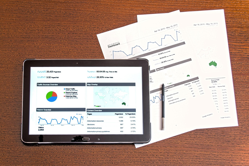 fund manager desk with reports showing underperformance vs index benchmark